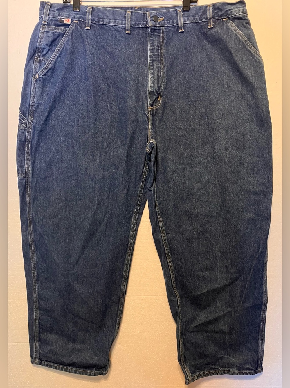 Carhartt FR Relaxed Fit Men's 44x30 Work Jeans in Dark Blue Denim frayed at Cuff